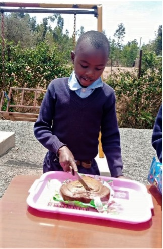 Child cuting a cake